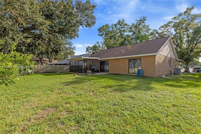 5506 Redhawk Dr, New Port Richey, FL 34655 - rear view of property featuring a sunroom, stucco siding, and a shingled roof
