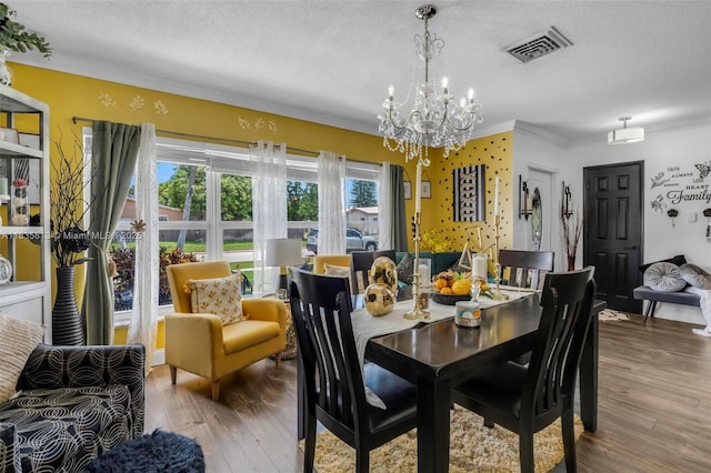 2239 NW 65th Ave, Margate, FL 33063 - dining space featuring a chandelier, crown molding, wood finished floors, and a textured ceiling