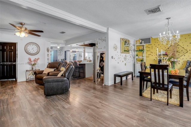2239 NW 65th Ave, Margate, FL 33063 - living area with ornamental molding, a chandelier, wood finished floors, ceiling fan, and a textured ceiling