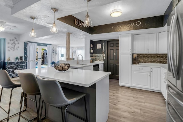 2239 NW 65th Ave, Margate, FL 33063 - kitchen featuring a breakfast bar, white cabinets, and tasteful backsplash