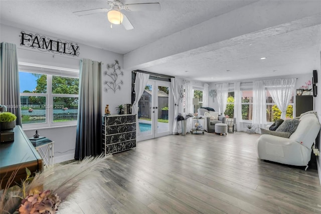 2239 NW 65th Ave, Margate, FL 33063 - living room featuring a textured ceiling, french doors, a ceiling fan, healthy amount of natural light, and wood finished floors