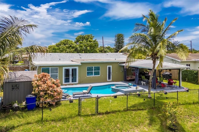 2239 NW 65th Ave, Margate, FL 33063 - rear view of house with french doors, a fenced backyard, a gazebo, and a pool with connected hot tub