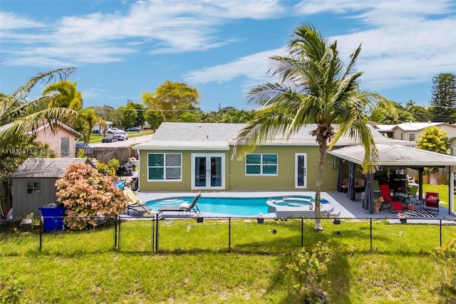 2239 NW 65th Ave, Margate, FL 33063 - back of house with french doors, a fenced backyard, a patio, a pool with connected hot tub, and a shed