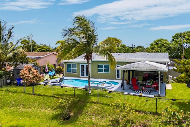 2239 NW 65th Ave, Margate, FL 33063 - back of property featuring a gazebo, french doors, a patio area, a fenced backyard, and a pool with connected hot tub