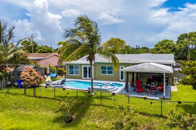 2239 NW 65th Ave, Margate, FL 33063 - rear view of property with a gazebo, french doors, a fenced backyard, a patio area, and a pool with connected hot tub
