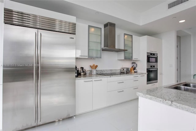 4100 Island Blvd Unit 2303, Aventura, FL 33160 - kitchen with stainless steel appliances, wall chimney exhaust hood, modern cabinets, light tile patterned floors, and glass insert cabinets