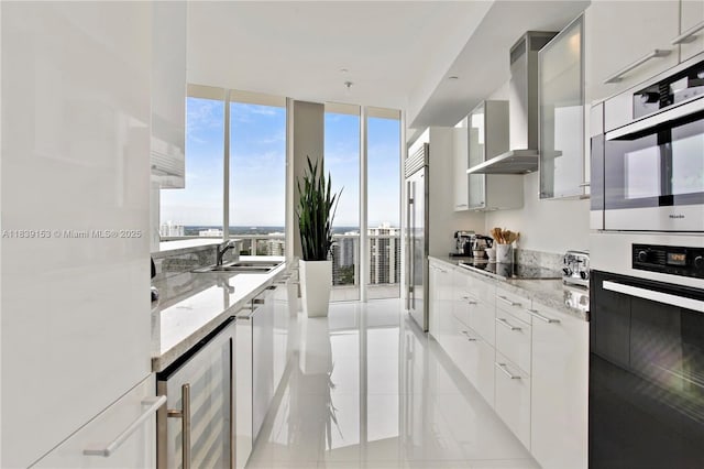 4100 Island Blvd Unit 2303, Aventura, FL 33160 - kitchen with wine cooler, modern cabinets, appliances with stainless steel finishes, wall chimney range hood, and a wall of windows