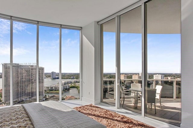4100 Island Blvd Unit 2303, Aventura, FL 33160 - bedroom with a wall of windows, a water view, multiple windows, and access to exterior