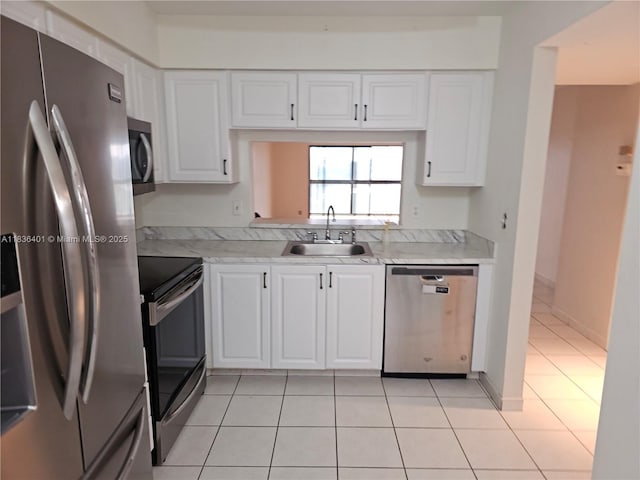 7270 Ashford Pl Unit 308, Delray Beach, FL 33446 - kitchen with appliances with stainless steel finishes, light tile patterned flooring, light countertops, and white cabinetry
