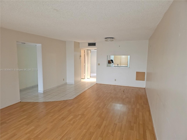 7270 Ashford Pl Unit 308, Delray Beach, FL 33446 - empty room with light wood finished floors and a textured ceiling