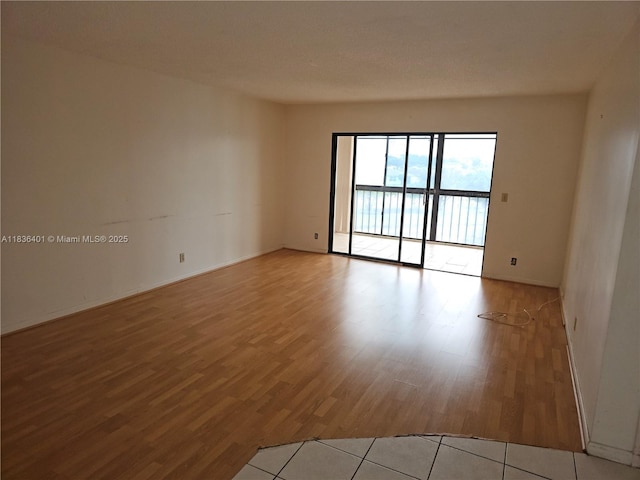 7270 Ashford Pl Unit 308, Delray Beach, FL 33446 - spare room featuring wood finished floors and baseboards