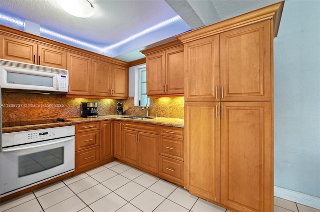 590 SW 62nd Ave, Miami, FL 33144 - kitchen with white appliances, decorative backsplash, light stone countertops, and light tile patterned floors