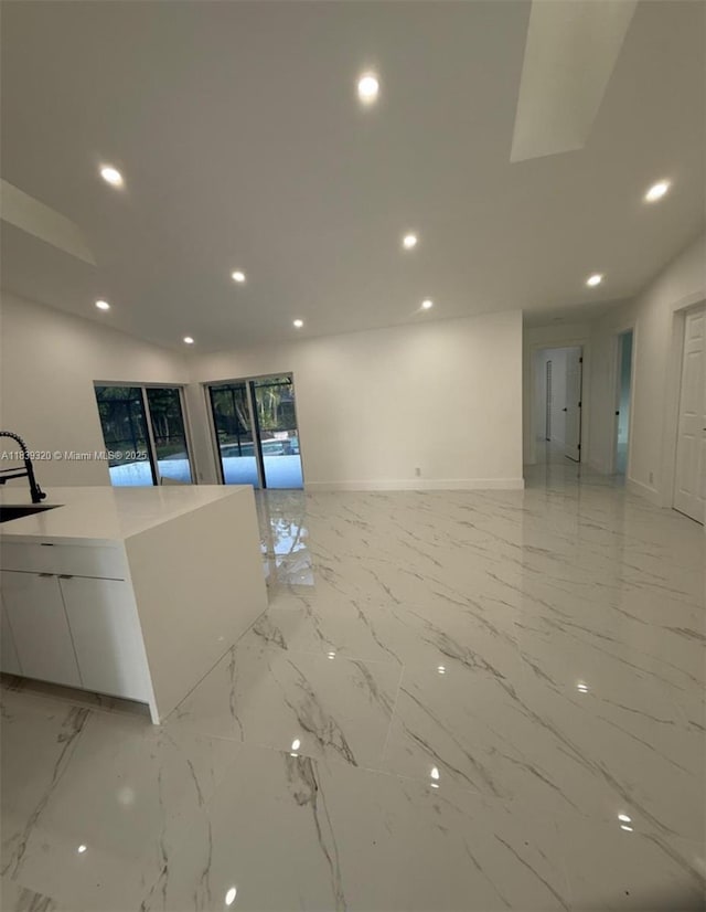 1655 NW 111th Way, Coral Springs, FL 33071 - unfurnished living room with recessed lighting and light marble finish floors