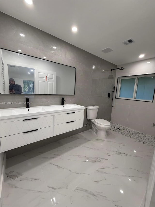 1655 NW 111th Way, Coral Springs, FL 33071 - bathroom featuring double vanity, tiled shower, tile walls, marble finish floors, and recessed lighting