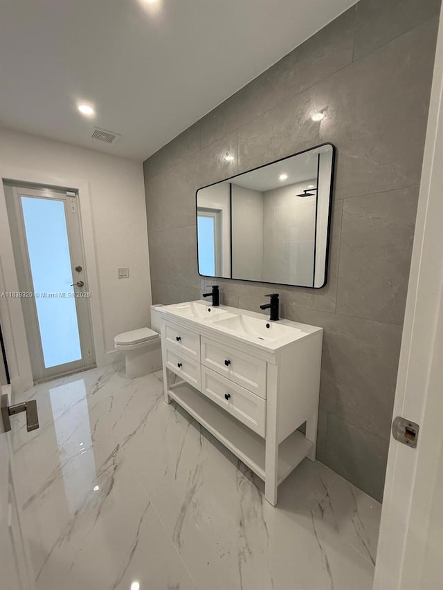 1655 NW 111th Way, Coral Springs, FL 33071 - bathroom with tile walls, double vanity, and marble finish flooring