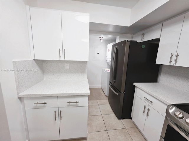 2620 S University Dr Unit 111, Davie, FL 33328 - kitchen with appliances with stainless steel finishes, white cabinets, light tile patterned floors, electric panel, and estacked washer and dryer