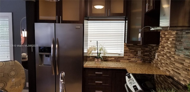 1337 Euclid Ave Unit 101, Miami Beach, FL 33139 - kitchen with stainless steel fridge with ice dispenser, black range with electric cooktop, ventilation hood, backsplash, and glass insert cabinets