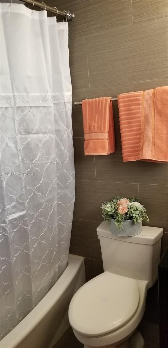 1337 Euclid Ave Unit 101, Miami Beach, FL 33139 - bathroom featuring tile walls and shower / bath combo with shower curtain