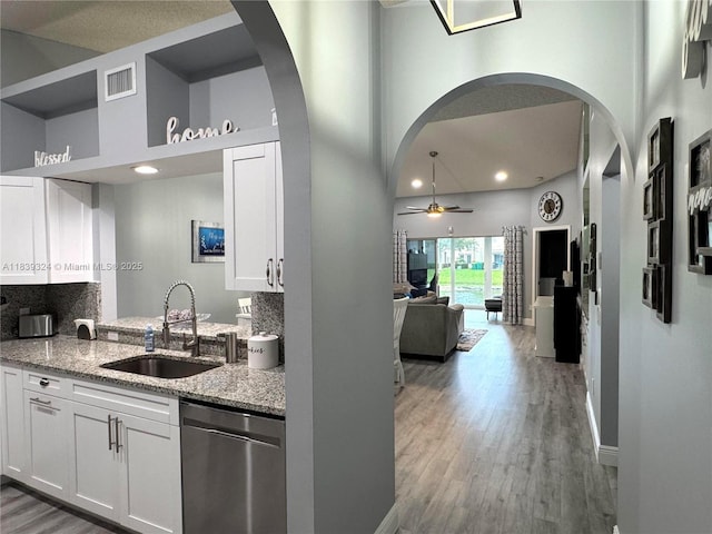5928 NW 93rd Ter, Tamarac, FL 33321 - kitchen featuring dishwasher, a high ceiling, ceiling fan, white cabinets, and light stone countertops