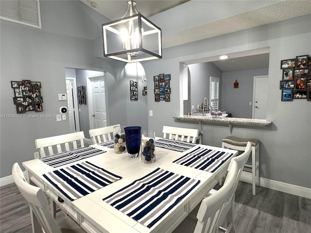 5928 NW 93rd Ter, Tamarac, FL 33321 - dining room with dark wood-style flooring and arched walkways