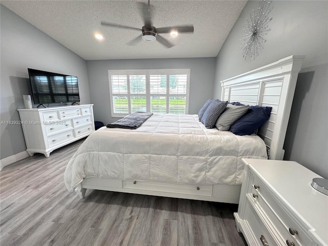 5928 NW 93rd Ter, Tamarac, FL 33321 - bedroom featuring wood finished floors, a textured ceiling, lofted ceiling, and a ceiling fan