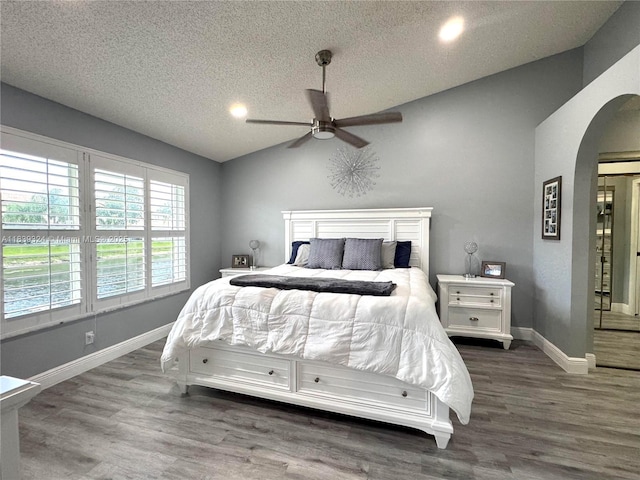5928 NW 93rd Ter, Tamarac, FL 33321 - bedroom with arched walkways, wood finished floors, a textured ceiling, vaulted ceiling, and ceiling fan
