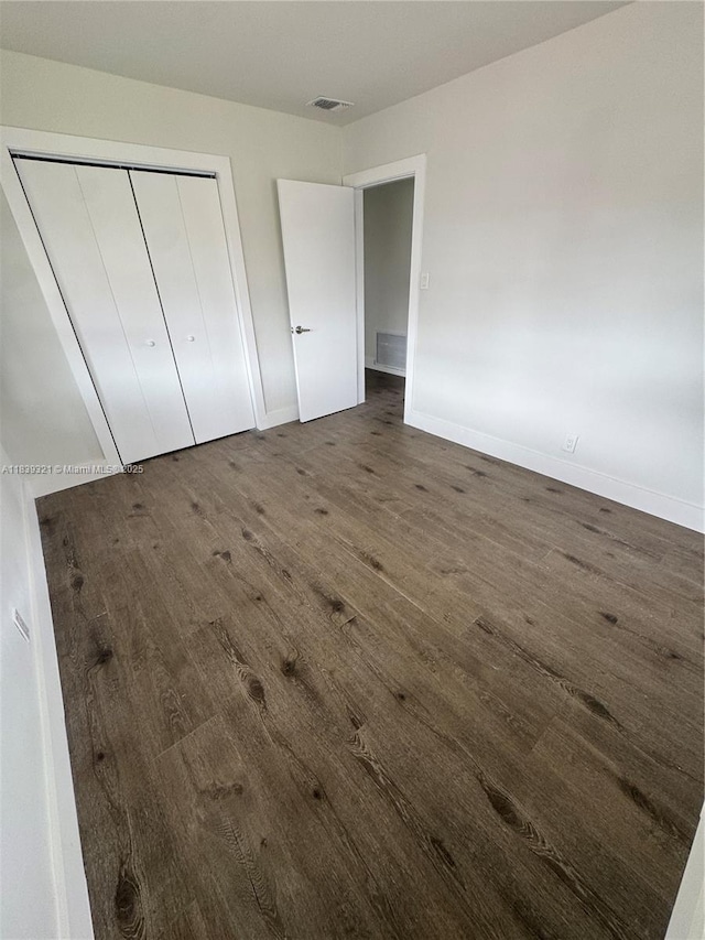 8521 NW 57th Ct, Tamarac, FL 33321 - unfurnished bedroom featuring wood finished floors and a closet