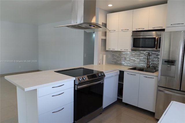 471 Capri J Unit 471, Delray Beach, FL 33484 - kitchen featuring stainless steel appliances, island range hood, a peninsula, light countertops, and backsplash