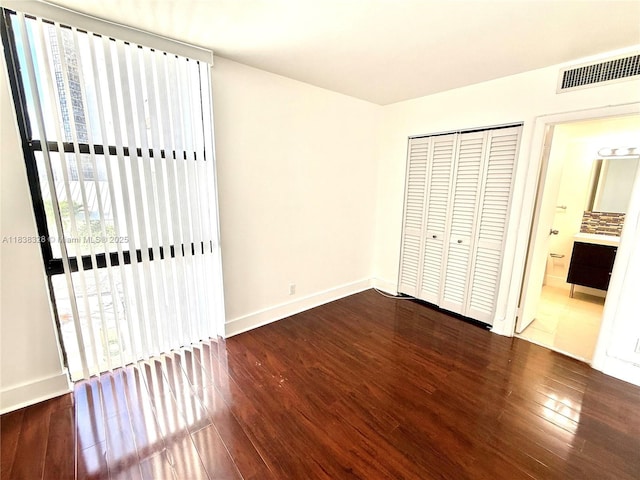 20335 W Country Club Dr Unit 502, Aventura, FL 33180 - unfurnished bedroom featuring wood finished floors, a closet, and connected bathroom