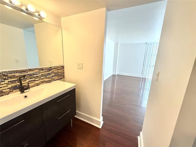 20335 W Country Club Dr Unit 502, Aventura, FL 33180 - bathroom with vanity, wood finished floors, and tasteful backsplash
