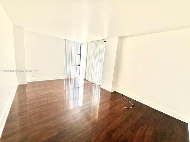 20335 W Country Club Dr Unit 502, Aventura, FL 33180 - empty room featuring dark wood-type flooring and baseboards