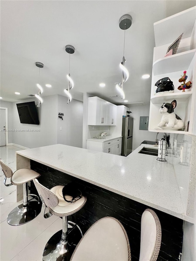 6120 SW 15th Ct, North Lauderdale, FL 33068 - kitchen with stainless steel refrigerator with ice dispenser, open shelves, a kitchen bar, light stone countertops, and white cabinetry