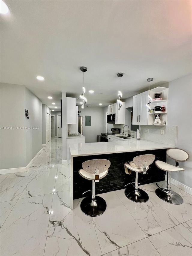 6120 SW 15th Ct, North Lauderdale, FL 33068 - kitchen featuring light marble finish floors, a breakfast bar, a peninsula, open shelves, and white cabinetry