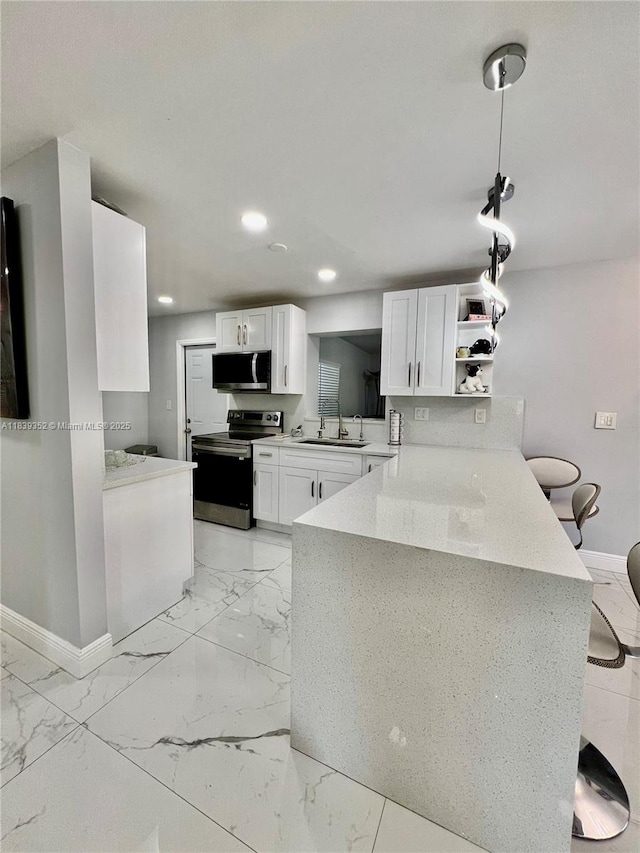 6120 SW 15th Ct, North Lauderdale, FL 33068 - kitchen featuring appliances with stainless steel finishes, light marble finish flooring, a peninsula, and recessed lighting