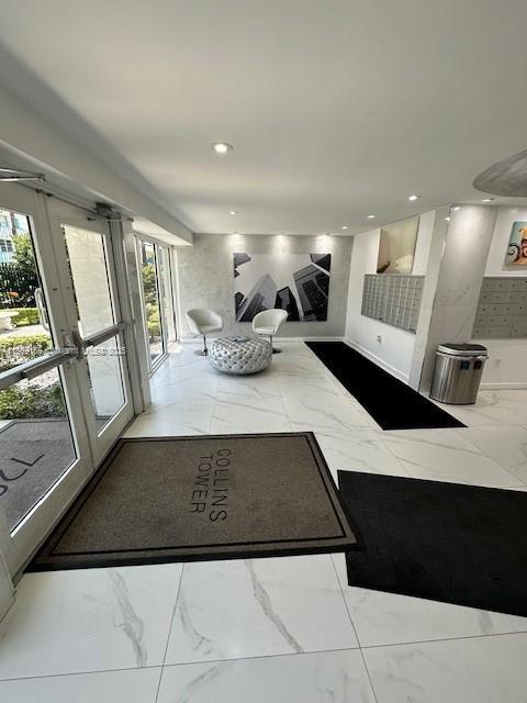 720 Collins Ave Unit 310, Miami Beach, FL 33139 - living area with marble look tiles, plenty of natural light, french doors, and recessed lighting