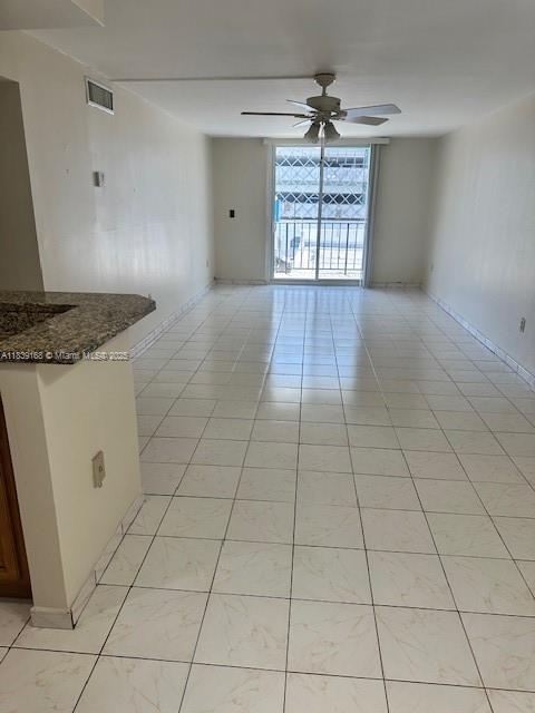 720 Collins Ave Unit 310, Miami Beach, FL 33139 - spare room featuring ceiling fan and light tile patterned flooring