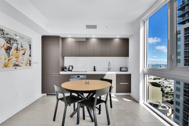 227 NE 2nd St Unit 2000, Miami, FL 33132 - dining area with healthy amount of natural light, bar with sink, and light tile patterned floors