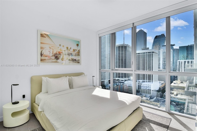 227 NE 2nd St Unit 2000, Miami, FL 33132 - bedroom featuring a wall of windows, tile patterned flooring, and a skyline view