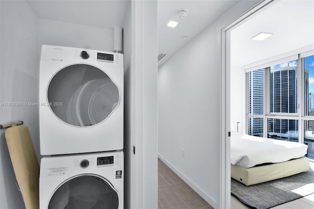 227 NE 2nd St Unit 2000, Miami, FL 33132 - laundry area with stacked washer / dryer and tile patterned floors