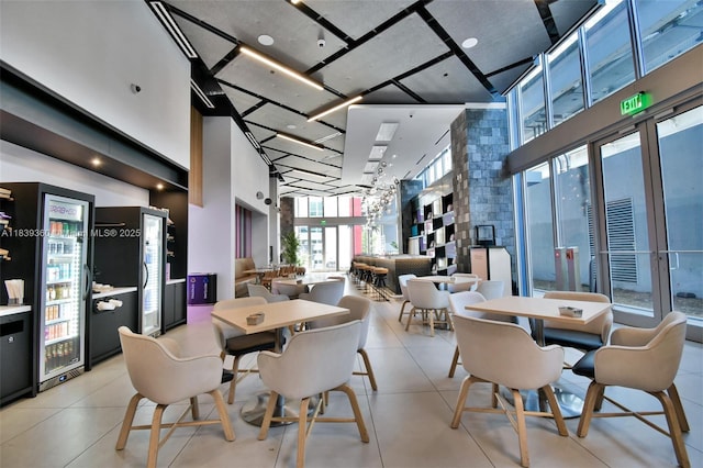 227 NE 2nd St Unit 2000, Miami, FL 33132 - tiled dining room featuring a high ceiling and a community bar