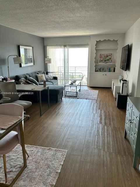 400 S Kings Point Dr Unit 806, Sunny Isles Beach, FL 33160 - living room featuring wood finished floors and a textured ceiling