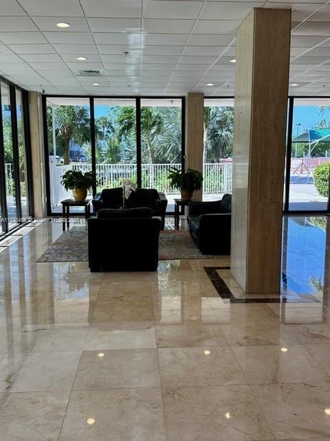 400 S Kings Point Dr Unit 806, Sunny Isles Beach, FL 33160 - building lobby with floor to ceiling windows and a drop ceiling