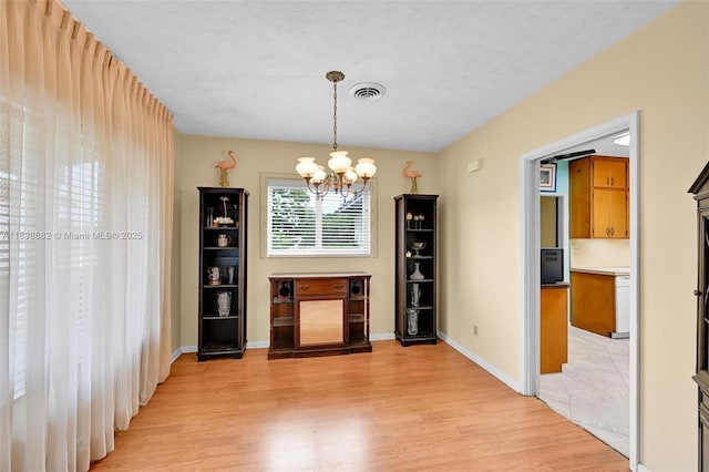 85 NW 21st St, Homestead, FL 33030 - unfurnished dining area with a chandelier and light wood-style floors