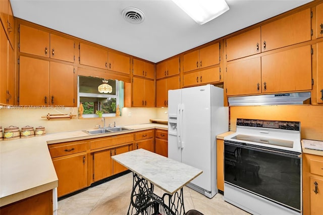 85 NW 21st St, Homestead, FL 33030 - kitchen with range with electric stovetop, white fridge with ice dispenser, under cabinet range hood, and light countertops