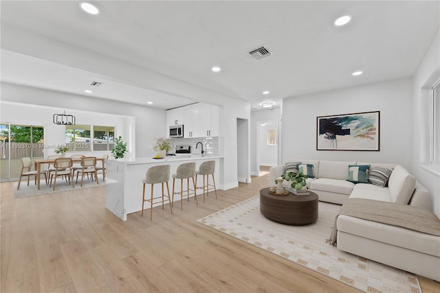 7021 SW 12th St, Pembroke Pines, FL 33023 - living room featuring light wood finished floors and recessed lighting