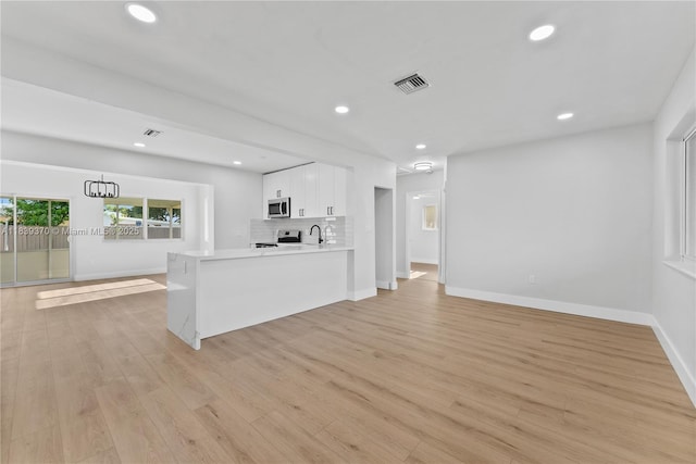 7021 SW 12th St, Pembroke Pines, FL 33023 - unfurnished living room featuring light wood-style flooring and recessed lighting