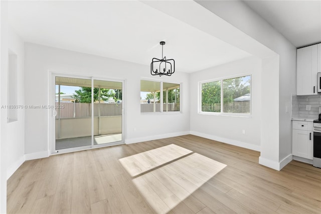 7021 SW 12th St, Pembroke Pines, FL 33023 - unfurnished dining area featuring a chandelier and light wood-style flooring