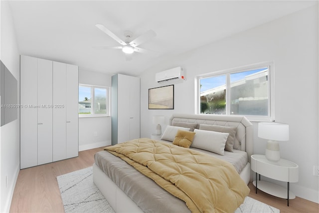 7021 SW 12th St, Pembroke Pines, FL 33023 - bedroom with a wall mounted air conditioner, light wood-style flooring, vaulted ceiling, and a ceiling fan