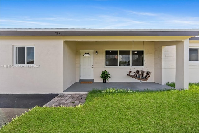 7021 SW 12th St, Pembroke Pines, FL 33023 - doorway to property with a yard and brick siding