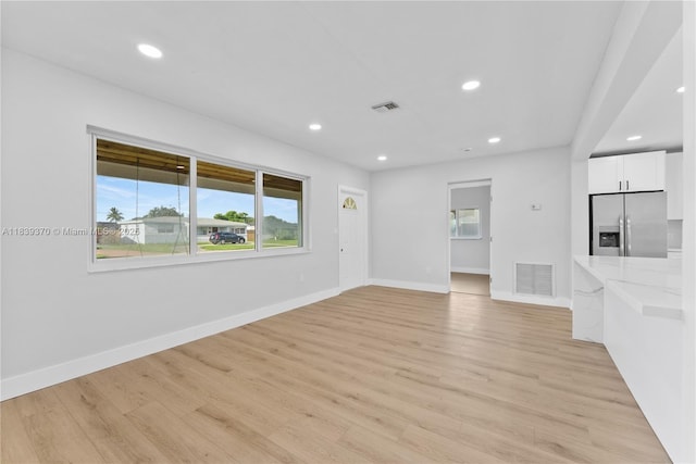 7021 SW 12th St, Pembroke Pines, FL 33023 - unfurnished living room featuring recessed lighting and light wood-type flooring